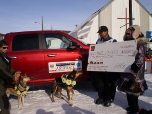 Lance Mackey poses with winner's check and the new truck he won. Photo attributed to jkbrooks85 on flickr.
